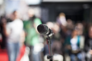 microphone in focus against blurred audience